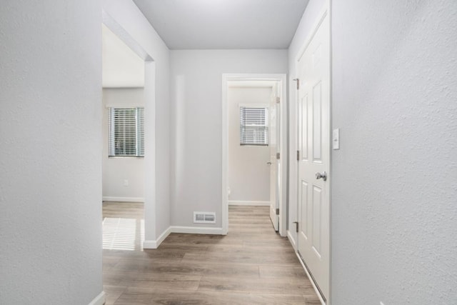 hall with light hardwood / wood-style floors