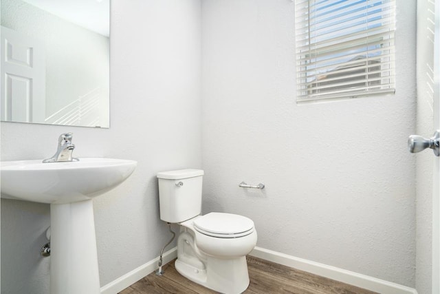 bathroom with sink, hardwood / wood-style floors, and toilet