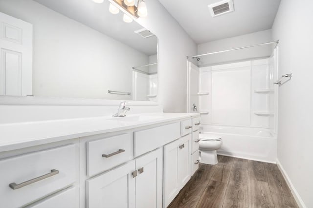 full bathroom featuring vanity, hardwood / wood-style flooring, shower / washtub combination, and toilet