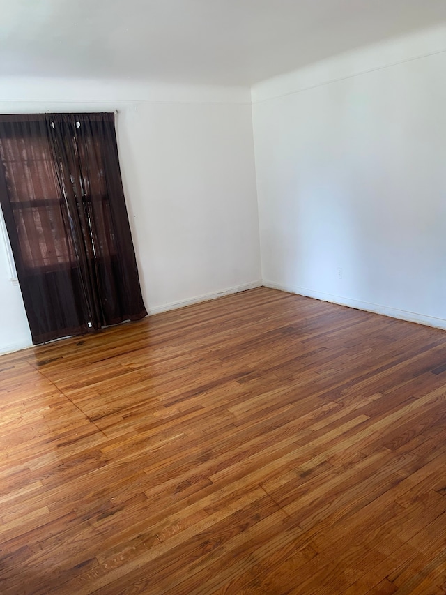 unfurnished room featuring hardwood / wood-style floors