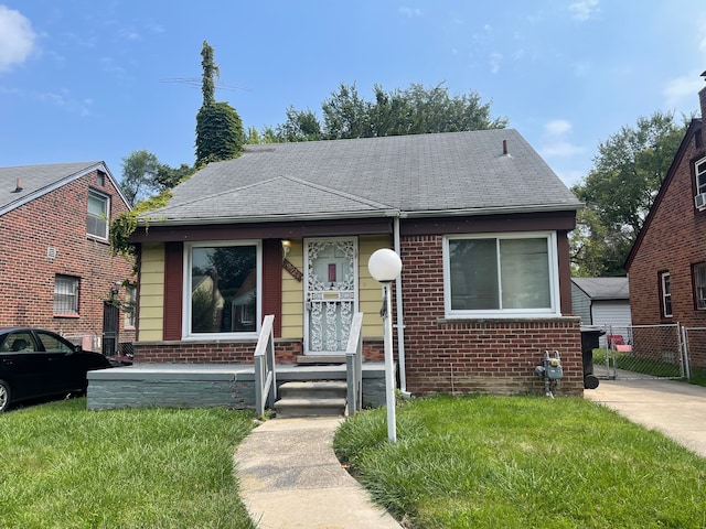 bungalow-style home featuring a front lawn