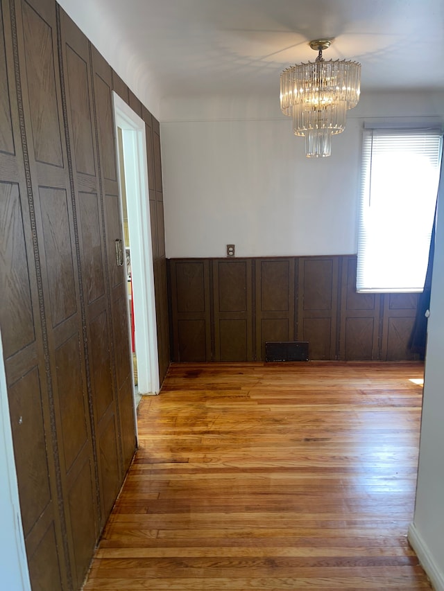 interior space featuring light hardwood / wood-style flooring and a notable chandelier