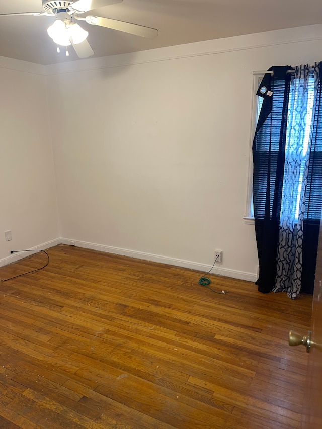 spare room featuring ceiling fan and dark hardwood / wood-style flooring