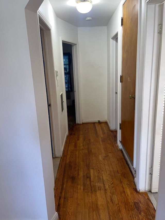 corridor with hardwood / wood-style floors