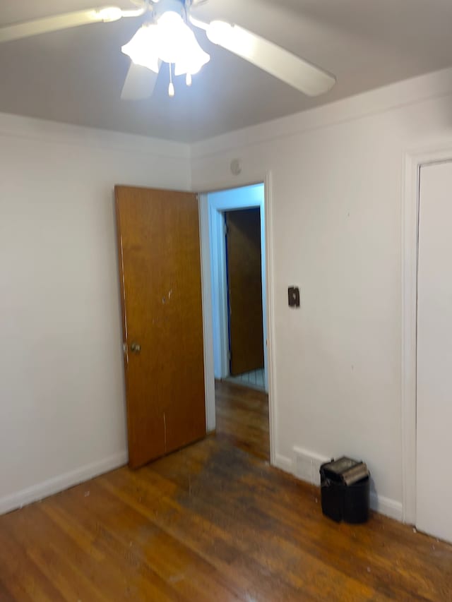 spare room with ceiling fan and dark hardwood / wood-style flooring