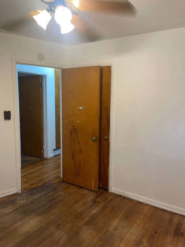 spare room with dark wood-type flooring