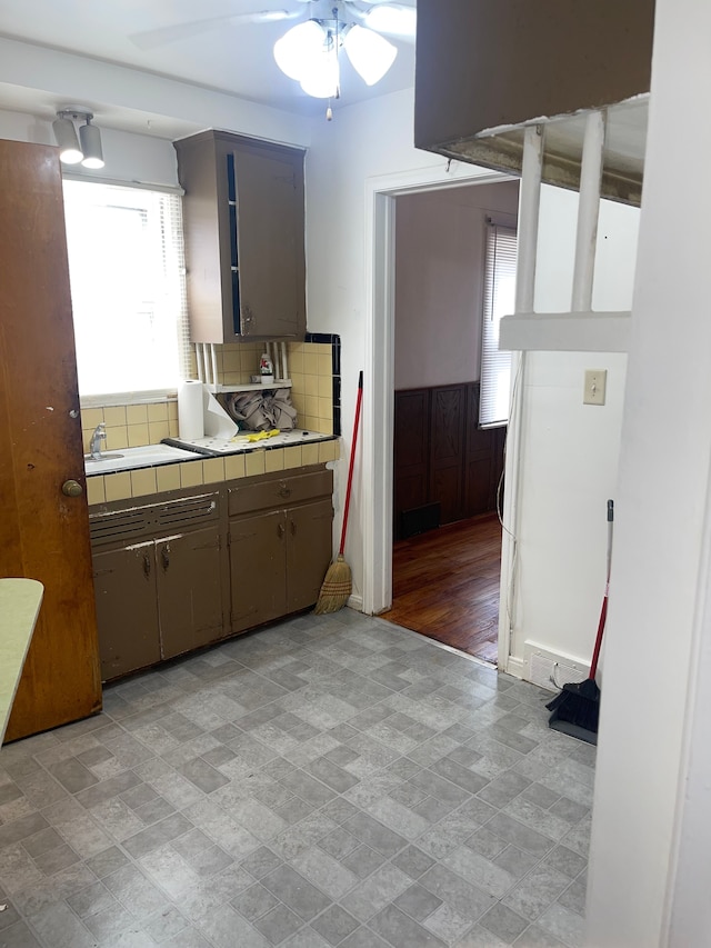 kitchen featuring backsplash, tile counters, and ceiling fan