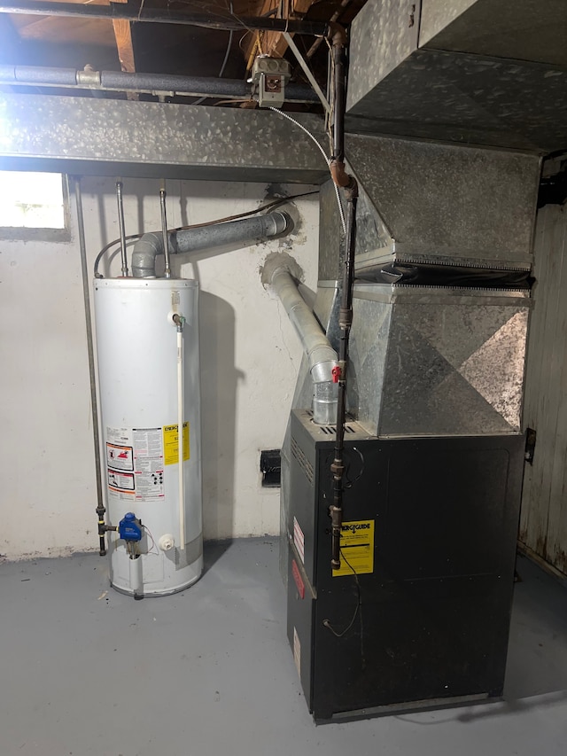 utility room with heating unit and water heater