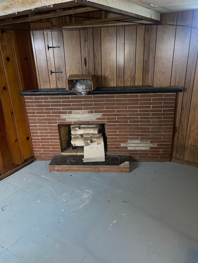 details with wooden walls and a brick fireplace