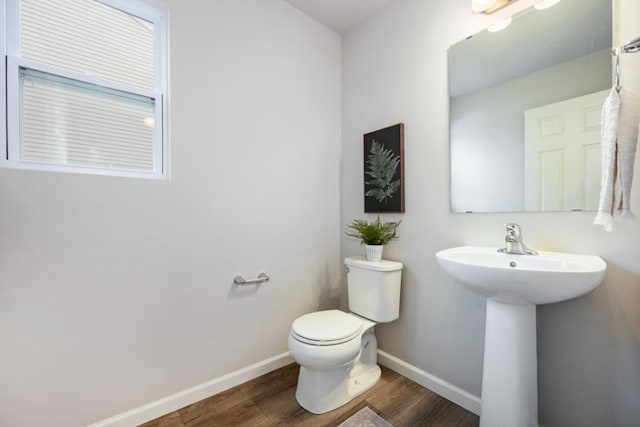 bathroom featuring sink, wood-type flooring, and toilet