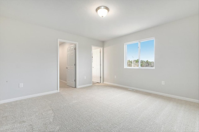 unfurnished room with light colored carpet