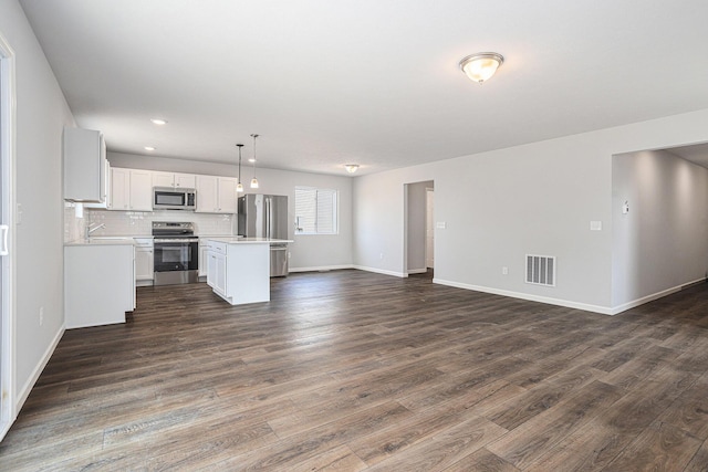 8745 E Sturtevant Ave, Richland, MI 49083 - unfurnished living room with dark wood-style floors and recessed lighting