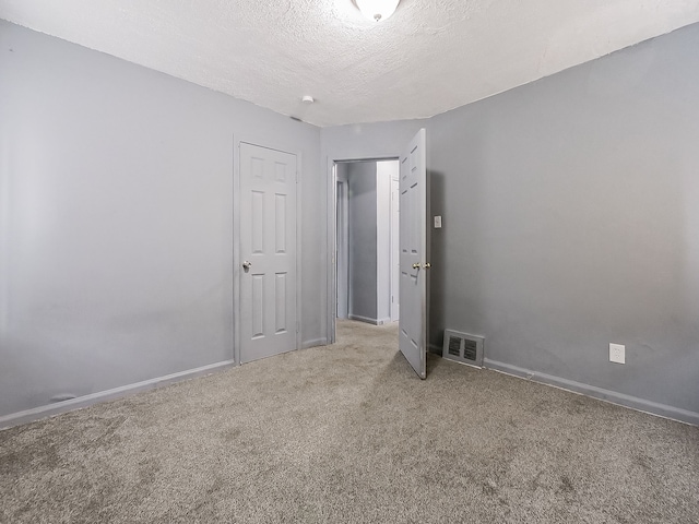 interior space with carpet and a textured ceiling