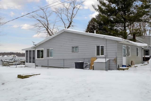 view of snow covered back of property