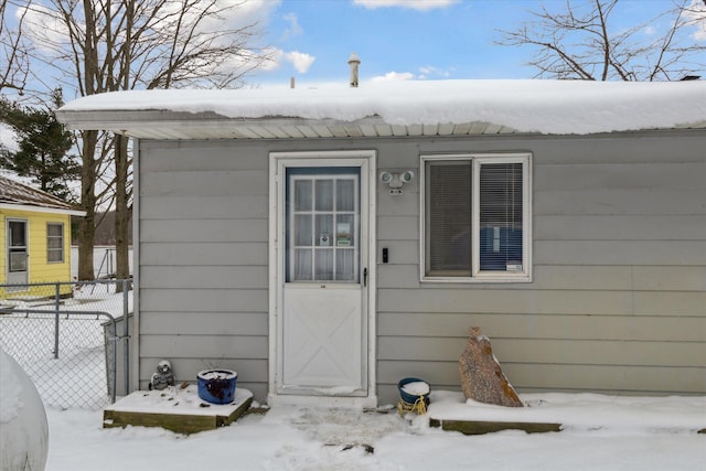 view of snow covered property entrance