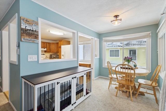 dining area featuring light carpet and a textured ceiling