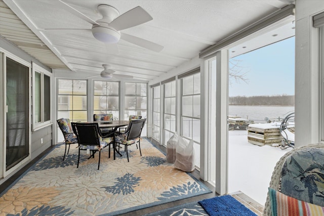 sunroom with ceiling fan and vaulted ceiling