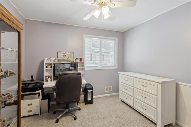 carpeted office space featuring ceiling fan and ornamental molding