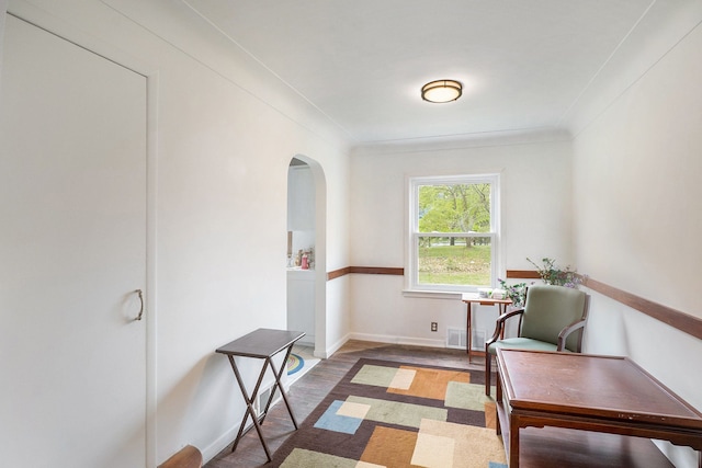 sitting room featuring dark hardwood / wood-style floors and crown molding