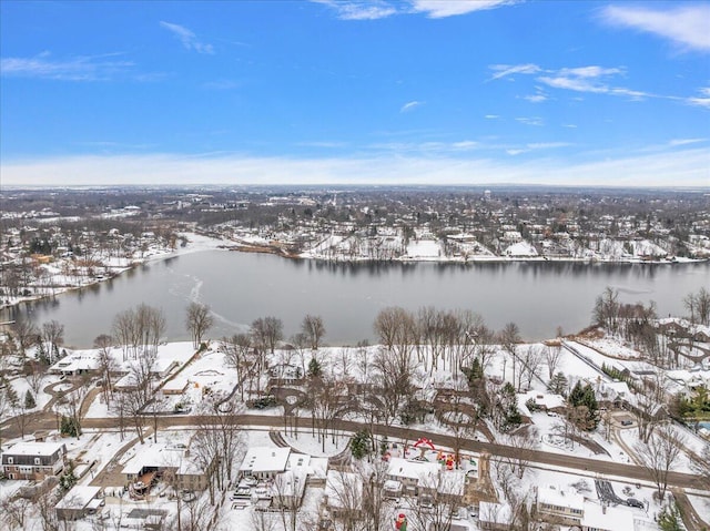 snowy aerial view with a water view