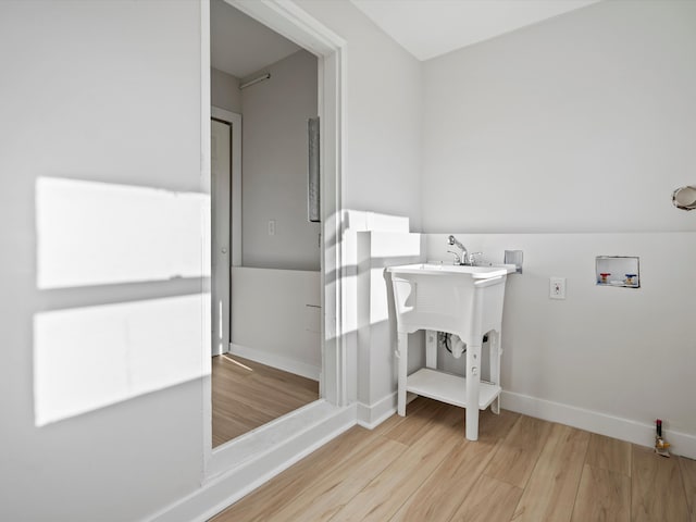 laundry room with washer hookup and light wood-type flooring