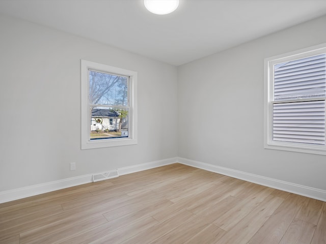 spare room featuring light hardwood / wood-style floors