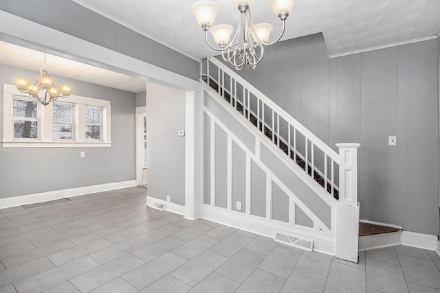 stairs with a notable chandelier and ornamental molding