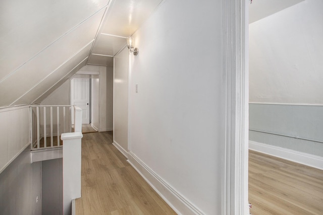 bonus room with lofted ceiling and light hardwood / wood-style floors