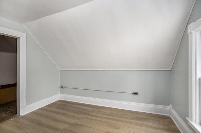 bonus room featuring wood-type flooring and vaulted ceiling