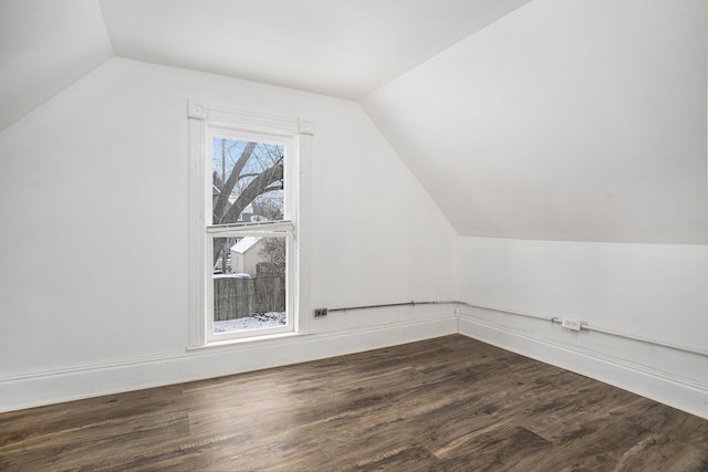 bonus room with vaulted ceiling and dark hardwood / wood-style floors