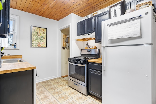 kitchen with wood counters, wood ceiling, stainless steel gas range, sink, and white refrigerator