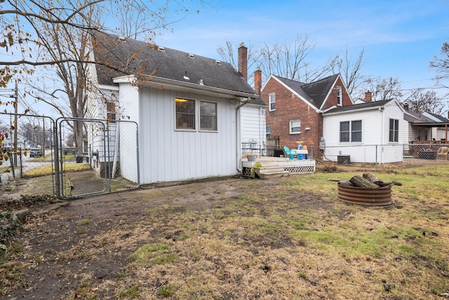 back of house with a lawn