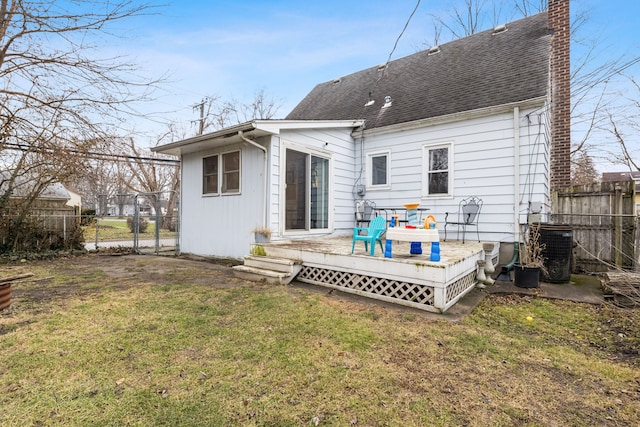 rear view of house with a yard, central AC unit, and a wooden deck