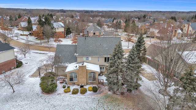 snowy aerial view with a residential view