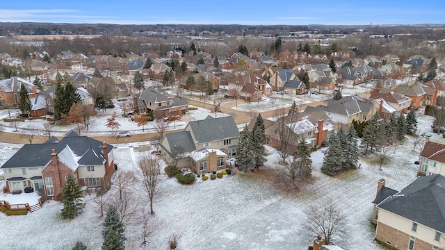 snowy aerial view with a residential view