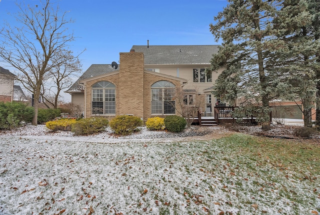 view of front of home with a chimney and a deck