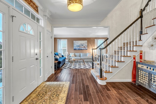 entryway with ornamental molding, dark wood-style flooring, stairway, and baseboards