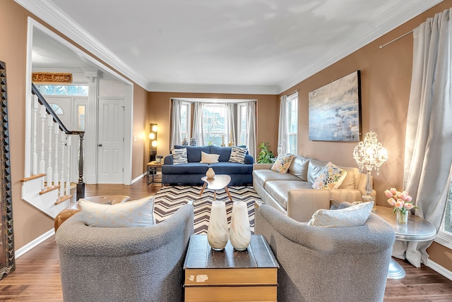 living area with baseboards, stairway, wood finished floors, and crown molding