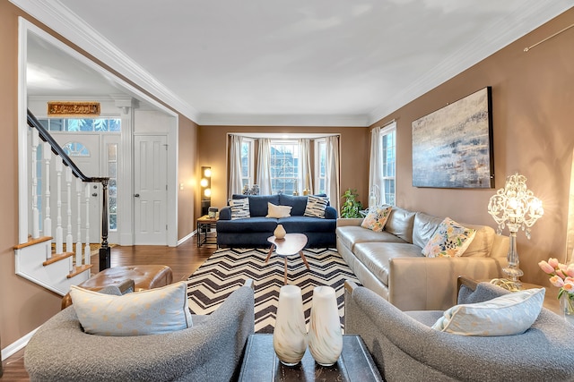 living area with baseboards, stairway, wood finished floors, and ornamental molding