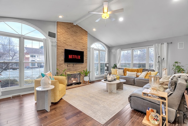 living area with dark wood-style floors, a fireplace, recessed lighting, lofted ceiling with beams, and ceiling fan