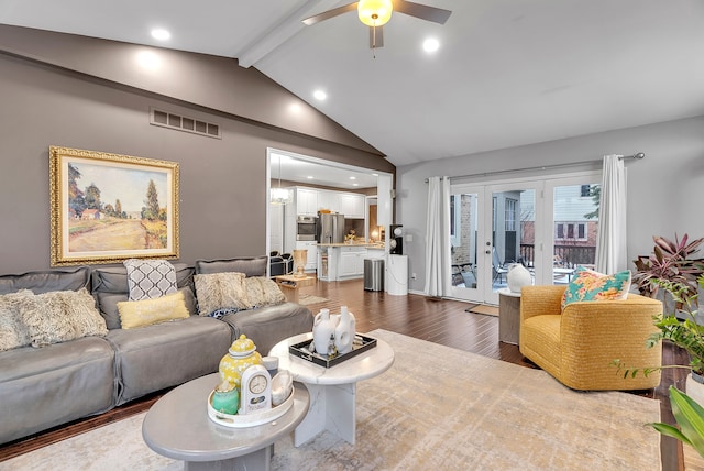 living area with visible vents, lofted ceiling with beams, ceiling fan, wood finished floors, and french doors