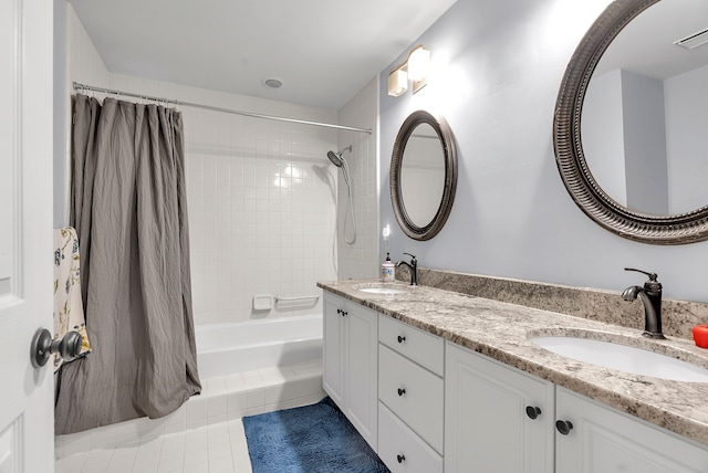 full bath with double vanity, tile patterned flooring, a sink, and visible vents