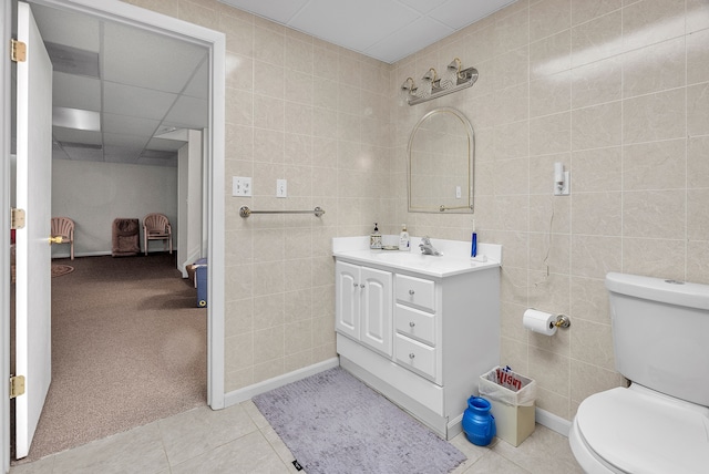 bathroom featuring toilet, tile walls, and tile patterned floors