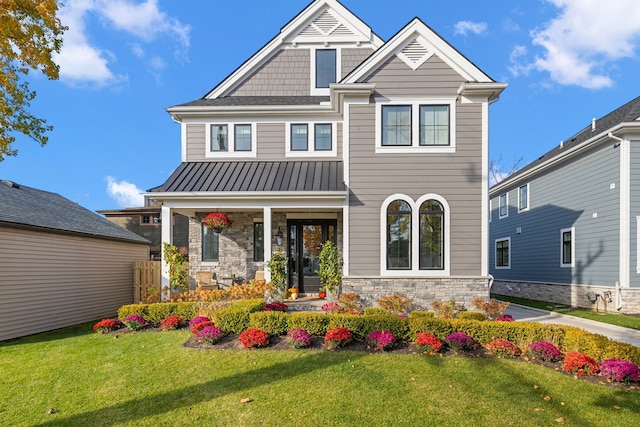 view of front of property featuring covered porch and a front lawn