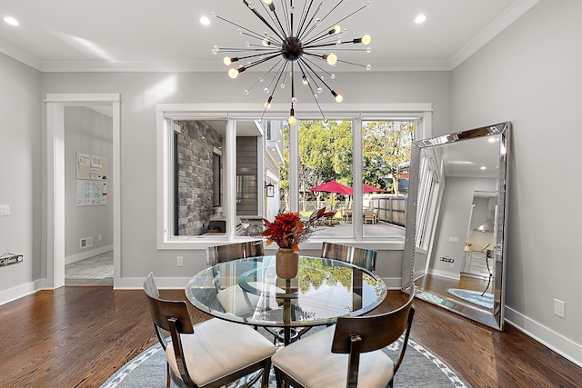 dining room featuring crown molding, dark hardwood / wood-style flooring, and an inviting chandelier