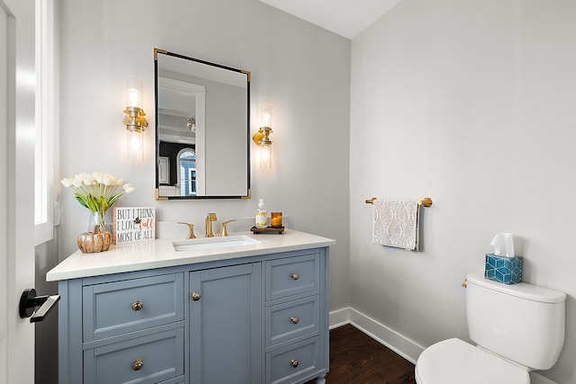 bathroom with vanity, hardwood / wood-style flooring, and toilet