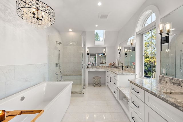 bathroom with an inviting chandelier, plenty of natural light, and independent shower and bath