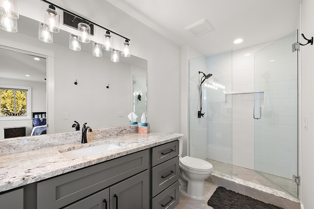 bathroom with tile patterned flooring, vanity, toilet, and a shower with door