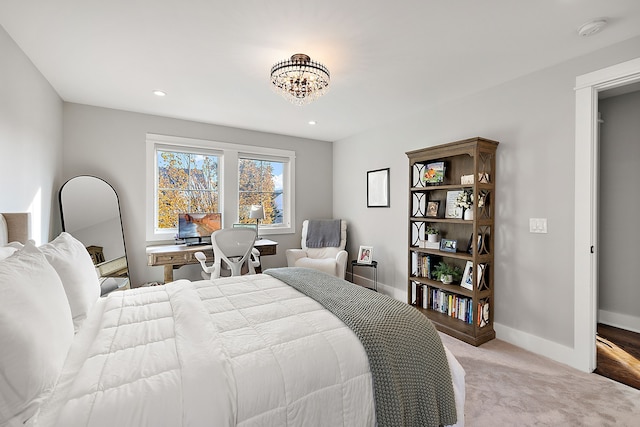 carpeted bedroom with an inviting chandelier