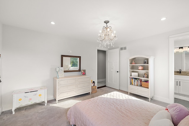 bedroom with a notable chandelier, light colored carpet, sink, and ensuite bath